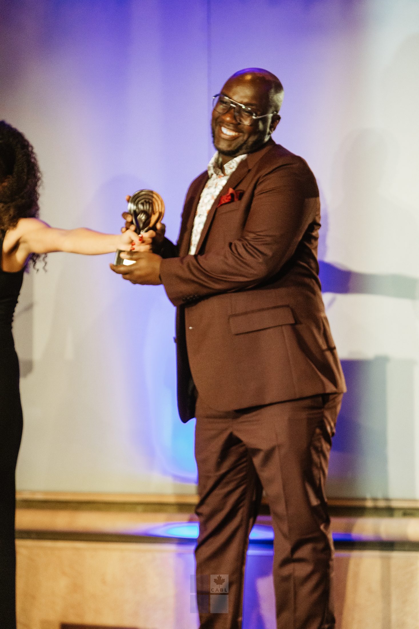 An award recipient, celebrated on stage.