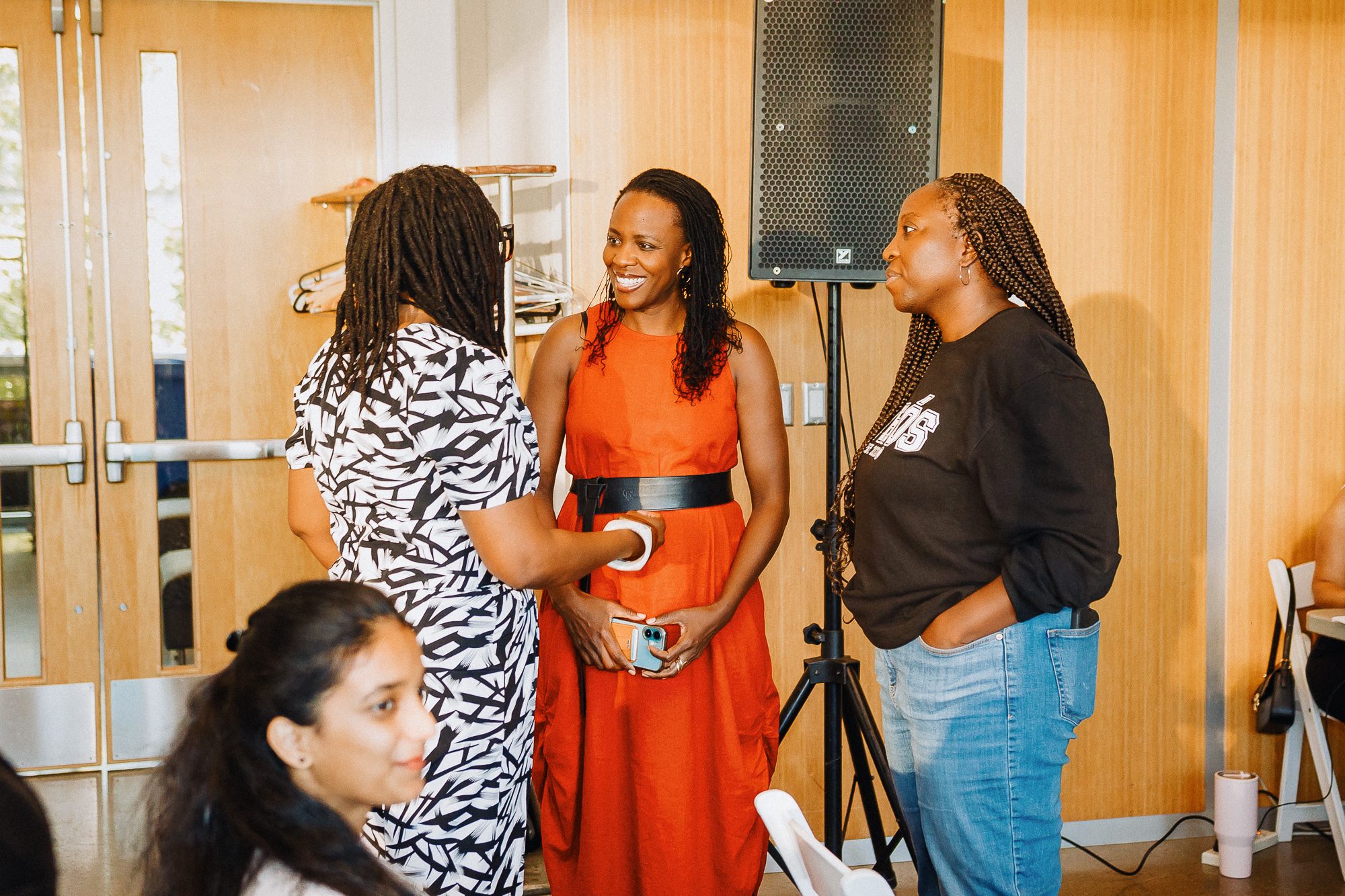 Guests catching up during the reception, mid-conversation and laughing.